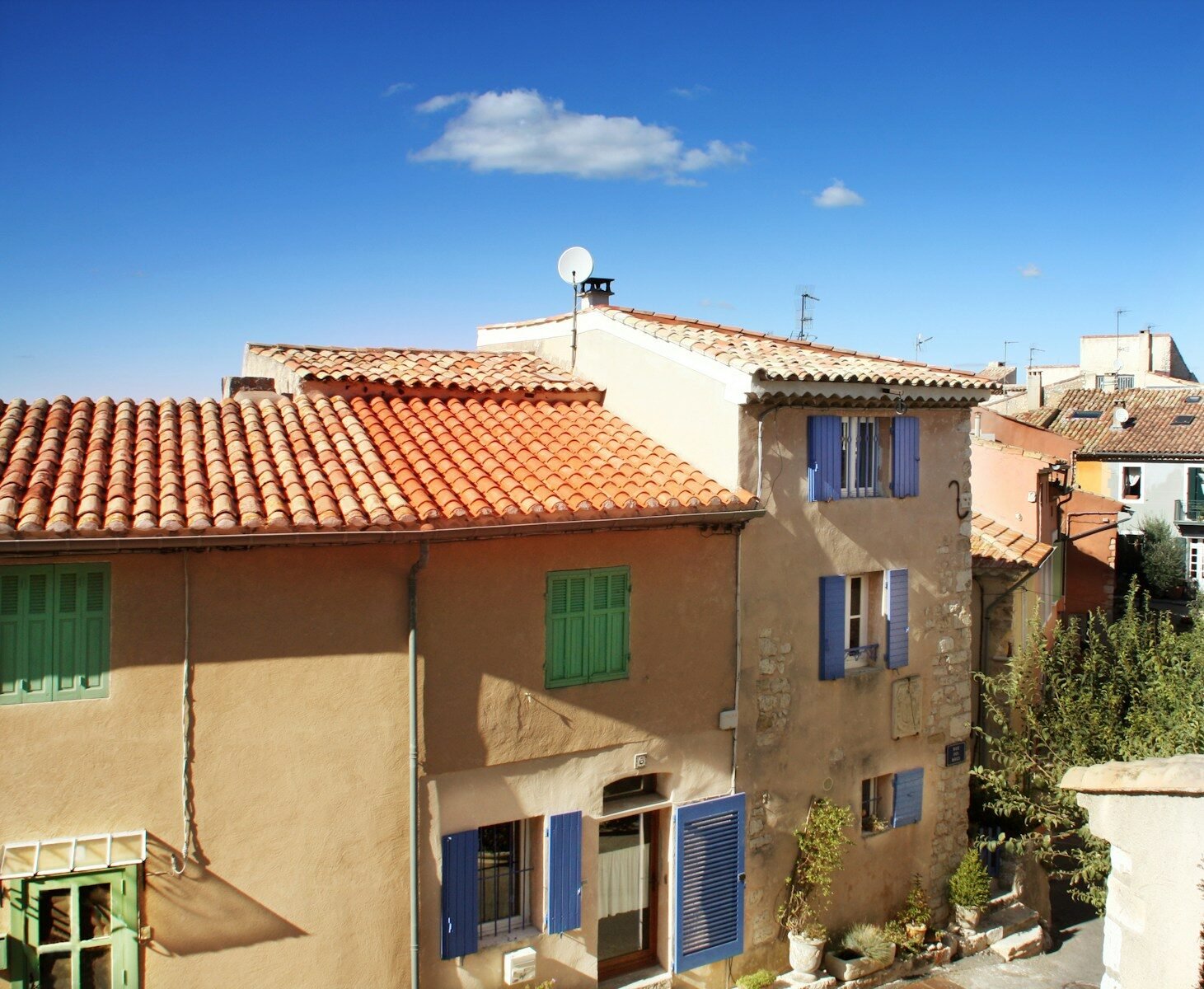 Terracotta rooftops under a bright blue sky.